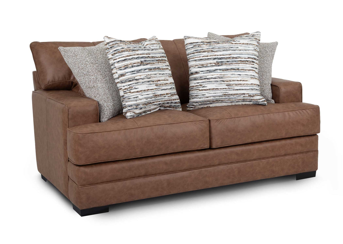 Brown sofa with patterned cushions on a white background