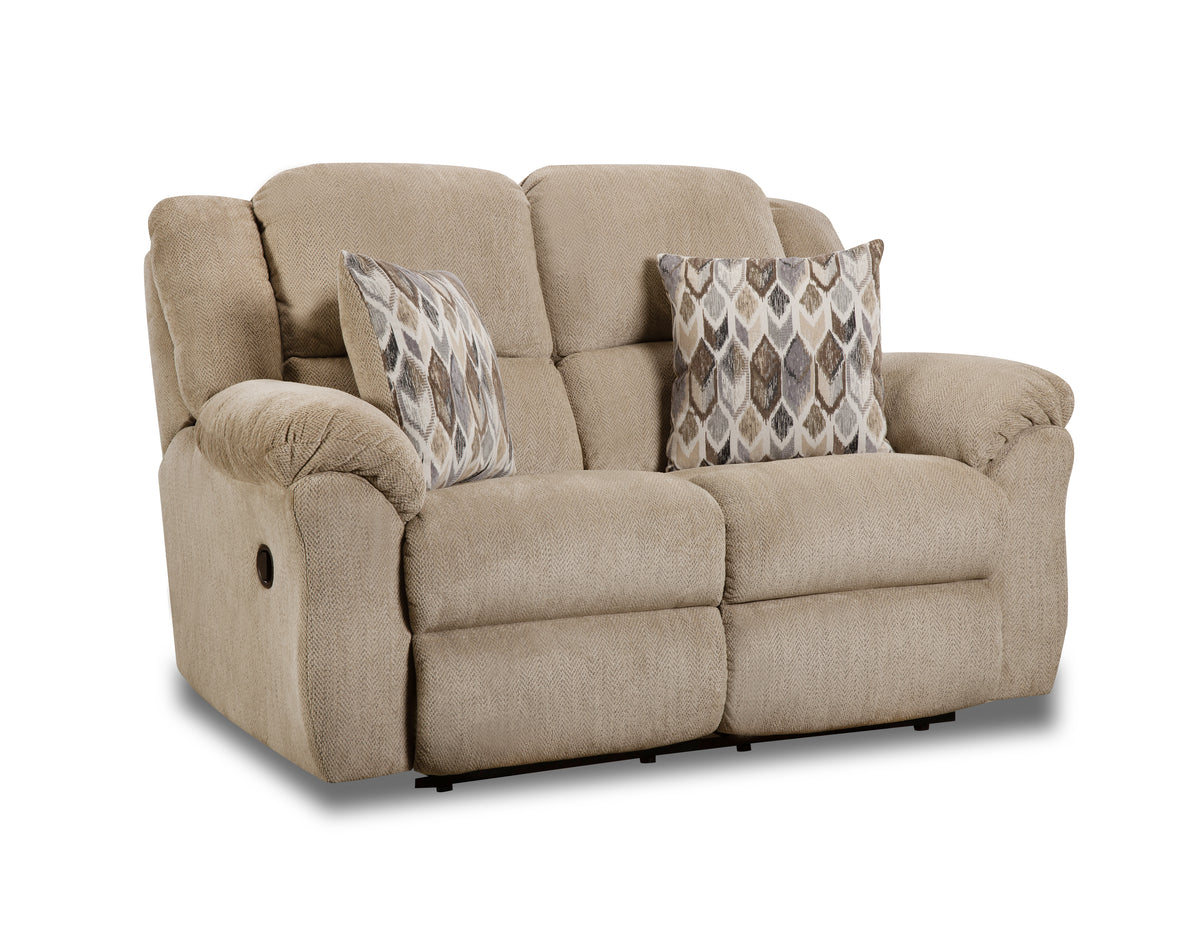 Beige reclining sofa with patterned cushions on a white background