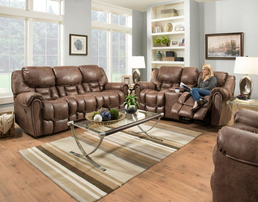 Brown leather reclining sofa set in a living room with a woman reading a book.