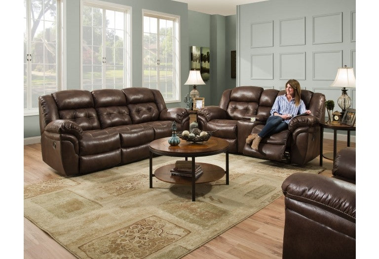 a room with a brown sofa, a brown loveseat, and a brown rocker recliner.
